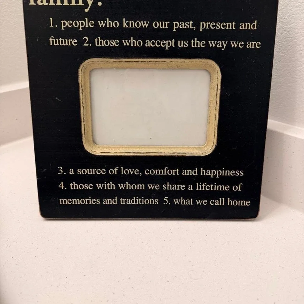 Black wooden picture frame with a quote about family